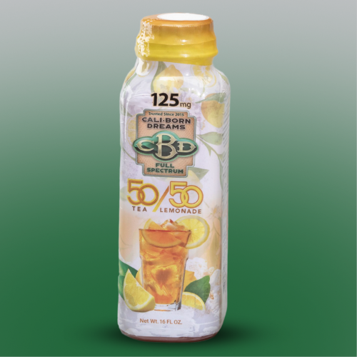 An image of a yellow bottle of CBD-infused 50 tea / 50 lemonade from Cali-Born Dreams, with a label displaying the product name, dosage, and ingredients. The bottle is placed on a green background, with droplets of condensation visible on its surface, indicating its chilled temperature